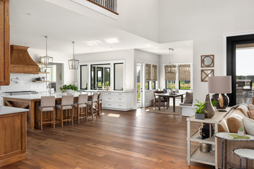 Living Room, Kitchen, and Eating Nook in New Luxury Home with Open Concept Floor Plan - obrazy, fototapety, plakaty