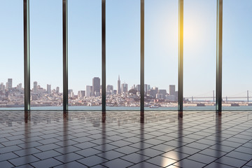 Contemporary modern office hall with glass walls and city view at background at sunrise.