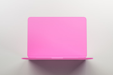 Minimal concept with onepiece single material pink laptop at abstract light background.