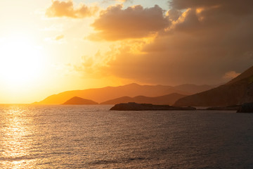 Naklejka na ściany i meble Sea and mountains at sunrise. Sunrise on the mediterranean sea.