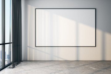 Blank poster on white wall in modern empty room with big windows and concrete floor, mock up.