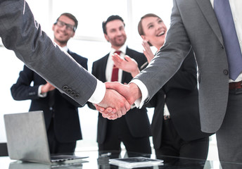 business handshake of business partners after signing the contract