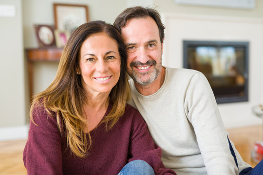 Beautiful romantic couple sitting together on the floor at home