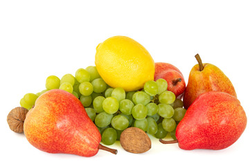 Sour ripe yellow lemon in a song with sweet green grapes, bright red fragrant pear with walnuts on white background