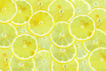 Pleasantly fragrant sour Golden yellow circles slices of fresh lemon with seeds seeds in the form of a cute background