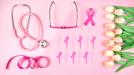 Pink Ribbon Breast Cancer Awareness Month concept flat lay on pink background.