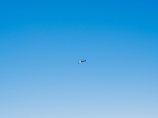 Business helicopter in the middle of the frame with clear blue sky Barcelona, Spain