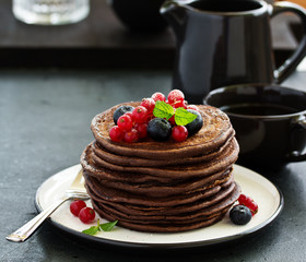 Chocolate pancakes with berries.