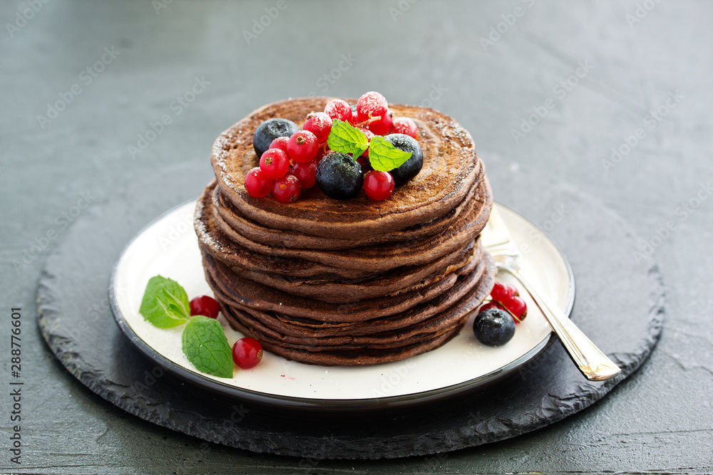 Poster Chocolate pancakes with berries.