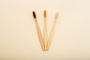 Eco-friendly bamboo tooth brush. Zero waste set on light beige natural background. Flat lay style.