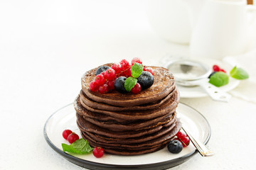 Chocolate pancakes with berries.