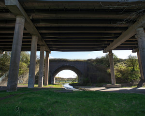 M6 flyover and canal aqueduct passing over channelised River Tame, West Midlands, UK