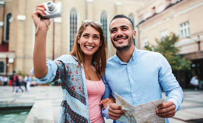 Young tourists enjoying in vacation, having fun together in the city. Concept of tourism