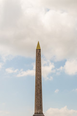 Vertical view of Egyptian Luxor obelisk located at Place de la Concorde, Paris, France on a cloudy day.  Detailed hieroglyphs can be seen