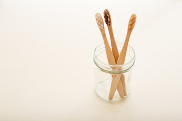 Eco-friendly bamboo tooth brush. Zero waste set on light beige natural background. Flat lay style.