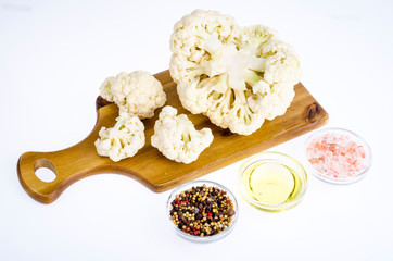 View of cauliflower on  cutting board, isolated.