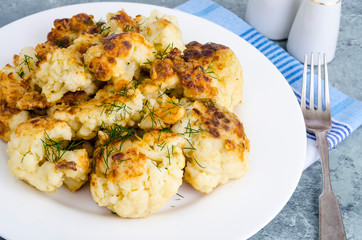 Fried cauliflower in batter on white plate