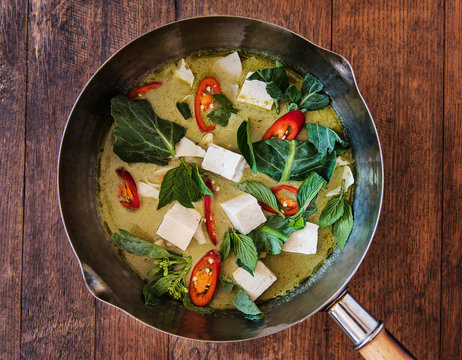Thai green curry with tofu and vegetables being prepared