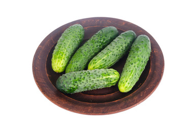 Fresh green cucumbers on ceramic bowl. Photo