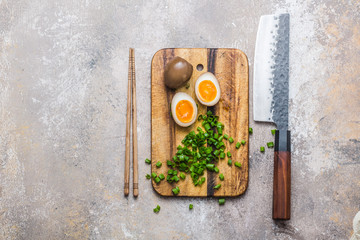 Japanese marinated eggs for ramen on cutting board, copy space