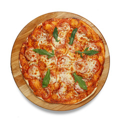 Appetizing pizza on a wooden board isolated on a white background. Top view.