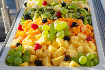 Mix fruit salad plate serving catering close-up