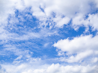 Blue skies shining through white clouds.