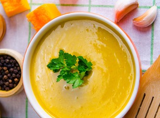 Pumpkin soup served on the table in bowl