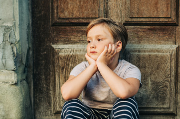 Outdoor portrait of handsom little boy with new haircut