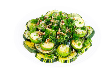 Fried zucchini with green greens, garlic and walnuts.