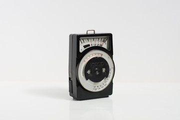 old selenium light meter for analog cameras on isolated white background. This device measures the intensity of the light for photography. right view
