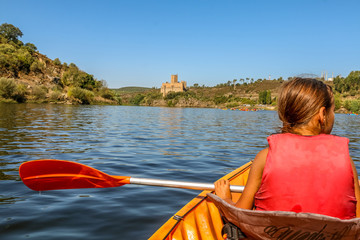 young girl on a boat in tagus river - templar castle of Almourol - Portugal