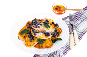 Tasty sweet pancakes with sugar and blueberries