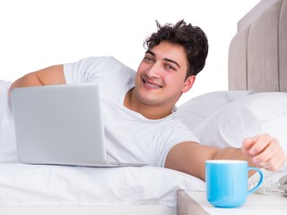 Man in bed suffering from insomnia