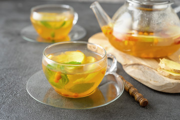 Tea set composition with hot tea on dark grey background