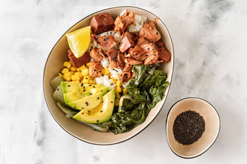 Vegan healthy bowl with rice, salad and jackfruit on dark backround