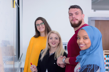 Fototapeta premium Group of multiethnic and multicultural architecture students with their Female Architecture teacher looking and smiling into camera during class.