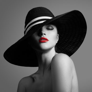 Elegant lady in hat. Black and white fashion portrait. Red lips.