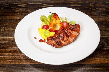 Grilled pork steak with caramel pear