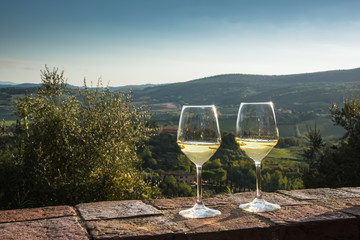 Two glasses of white wine outside on a ledge