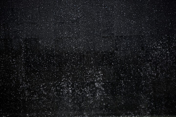 heavy rain against black night sky as background