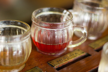 A day tour to visit a plantation of coffee and tea to taste different flavors with litle glass at Ubud, Bali, Indonesia
