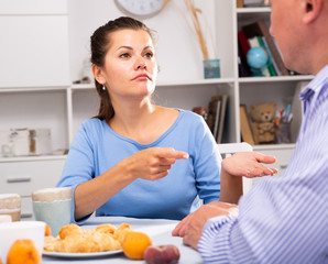 Wife threatens the finger of her husband at kitchen