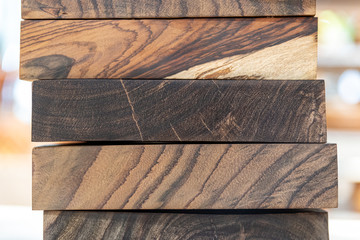 close up of wooden chopping boards in a stack on a shelf
