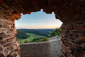 View of some Black Forest hills through a window opening in the castle ruin Hohengeroldseck