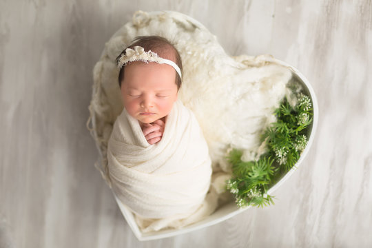 first photo shoot. newborn child. newborn.  the child lies in the white heart. newborn girl