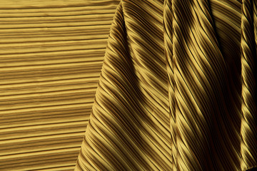 Pleat Fabric in long line drape with shadow, pleated style of textile pattern in Gold color put in layer design wave wallpaper, studio lighting close up background image