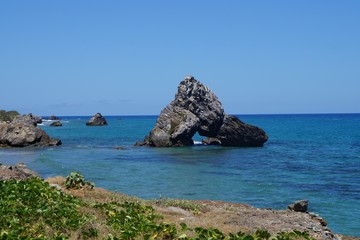 Fototapeta na wymiar playa piedras con formas grandes y espectaculares mar azul con cielo azul paisaje