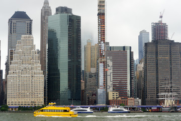 Fototapeta premium New York City Manhattan skyline panorama view over East River at rainy day.
