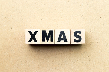 Obraz premium Letter block in word xmas on wood background (Concept for Christmas)